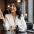 iScents blog — Best Perfumes for Women in Pakistan 2025 featuring woman with white blazer and coffee cup